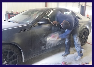 Juan fixing Cadi CTS door damage